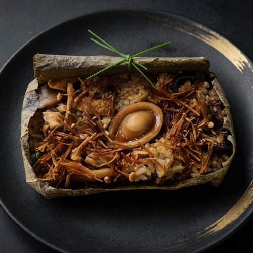Vegan abalone and double mushroom lotus leaf rice on plate