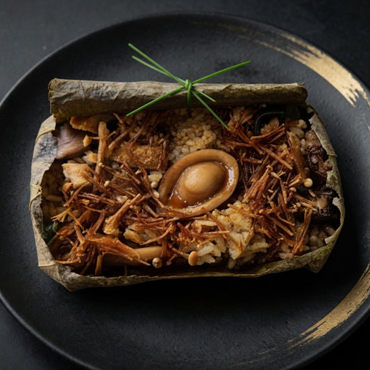 Vegan abalone and double mushroom lotus leaf rice on plate